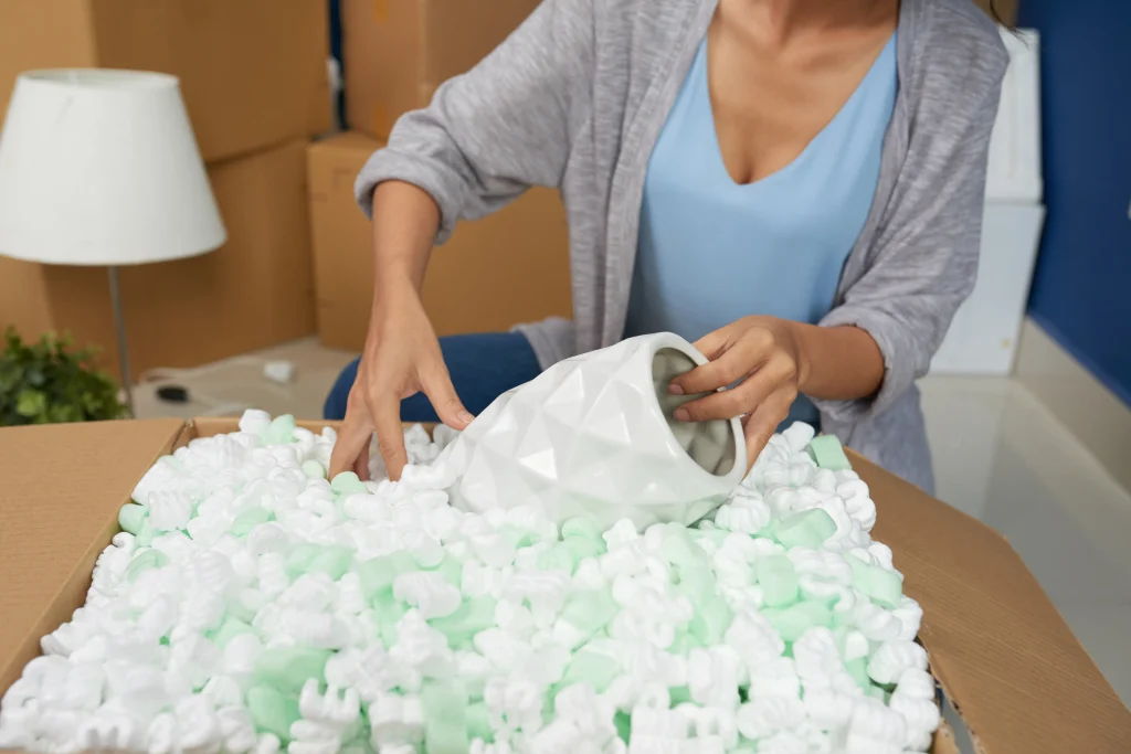 woman-unpacking-vase-with foam packaging