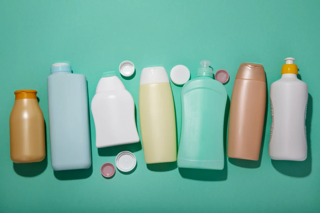 top-view-plastic-bottles-green-background