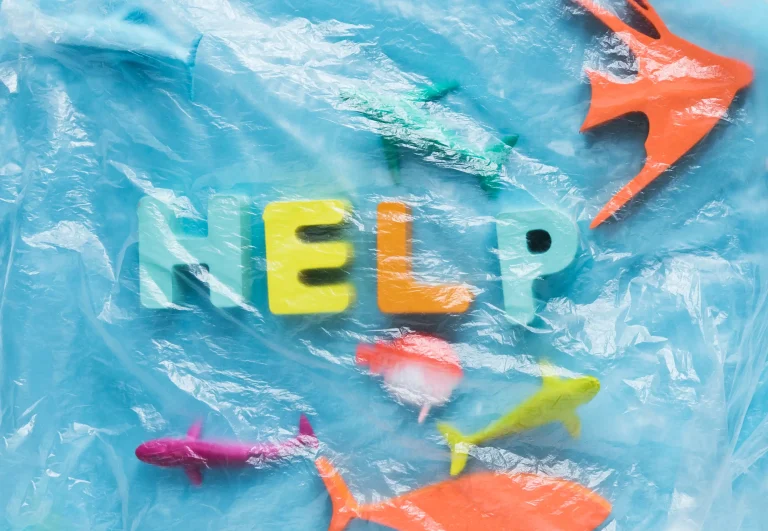 top-view-message-with-fish-figurines-plastic-wrap